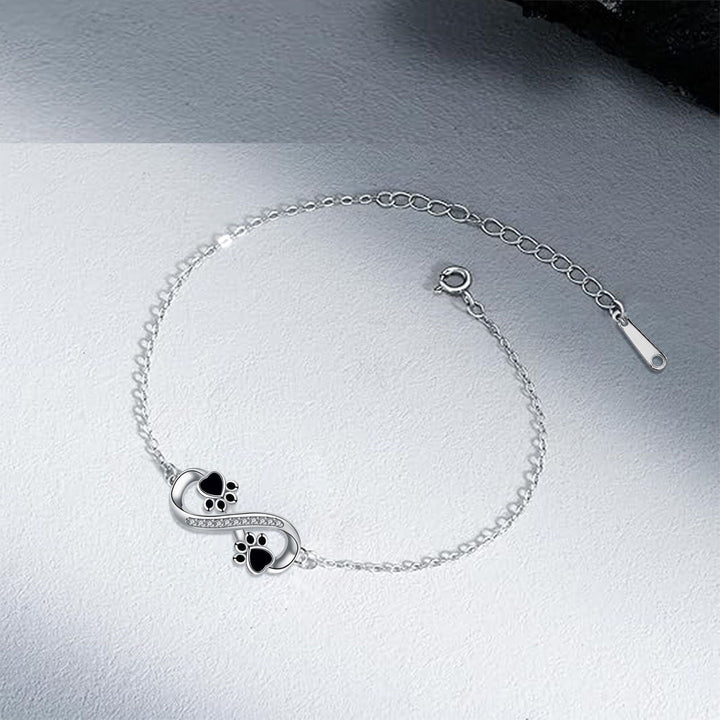 Bracelet avec symbole de l'infini, charms avec empreinte de patte et zircons
